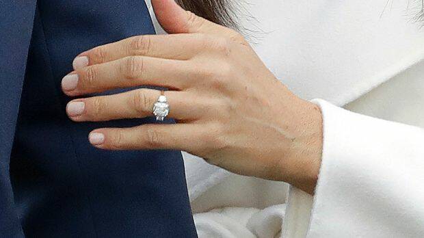 Britain's Prince Harry's fiancee Meghan Markle shows off her engagement ring. Photo: Matt Dunham

