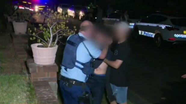 Police and partygoers outside the Gladesville home on Saturday night. Photo: Supplied/Channel 9
