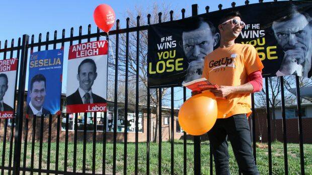 GetUp! supporter Girish Sagaram hands out how-to-vote cards at North Ainslie Primary School, ACT, on Saturday morning for the Federal Election. Photos: Scott Hannaford