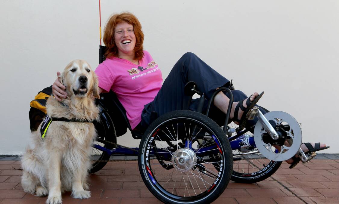 On her trike: Alice Verrall appreciates dogs like Taylor. Picture: Jane Dyson.
