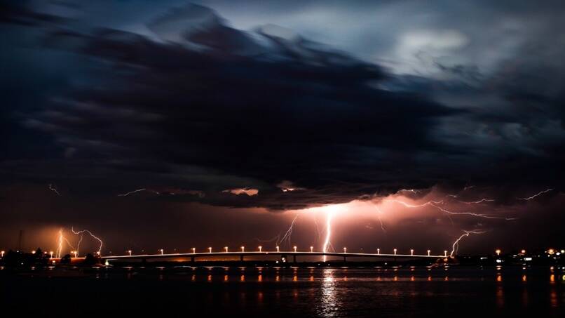 Light show: Reader Paul Wheeler sent in this photograph of the Saturday storm above the Captain Cook bridge.
