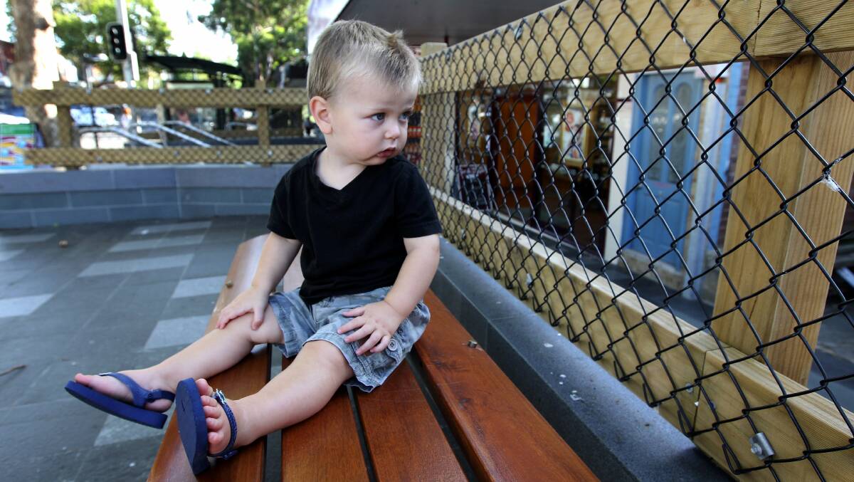 Fenced in: Mason, 2, checks out the ‘‘temporary’’ fence from one of the new seats that were installed during the upgrade. Picture: John Veage
