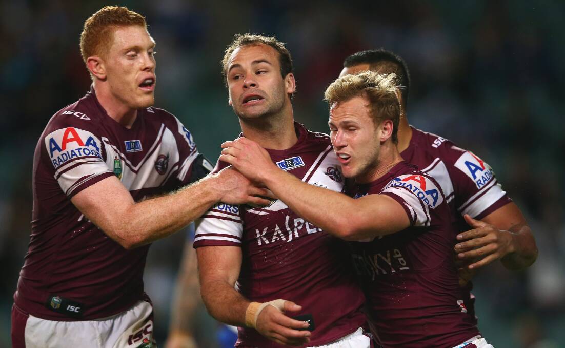 Team effort: Tom Symonds, Brett Stewart and Daly Cherry-Evans (right) of the Sea Eagles celebrate after Stewart scored a try against Canterbury Bulldogs in 2014. Picture: Mark Kolbe/Getty Images
