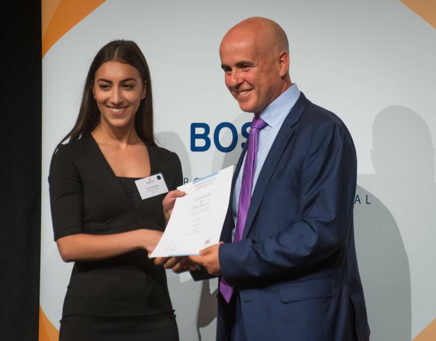 Teresa Repice receives the award from education minister Adrian Piccoli.
