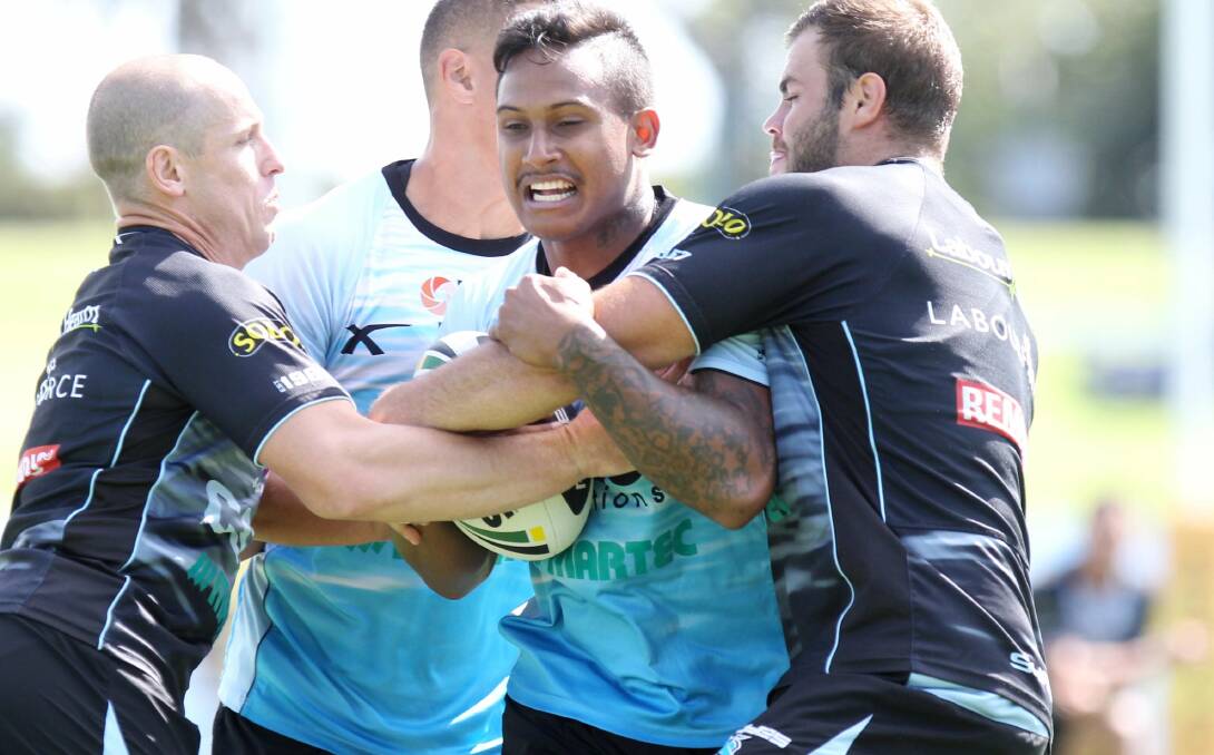 Shark net: Jeff Robson (left), Ben Barba and Mitch Brown rehearse defensive drills at training.
