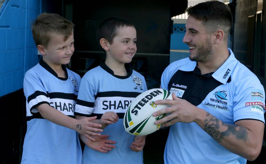 King of the kids: Sharks five-eighth Jack Bird with young fans Fletcher and Will. Picture: Jane Dyson
