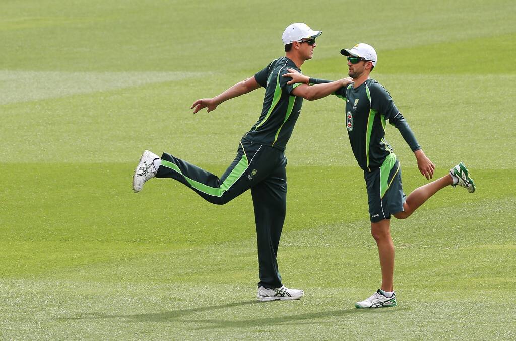 Josh Hazelwood (L) stretches with Nathan Lyon during an Australian nets session at Adelaide Oval. Picture: Michael Dodge/Getty Images
