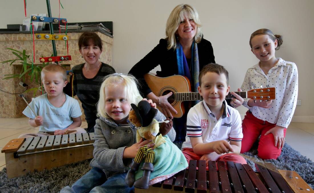 In harmony: School teachers Amanda DeLore and Jodie Pringle said children could benefit from their new venture. Here they are with William and Jessica Plumber and Toby and Scarlet Piper.Picture: Jane Dyson
