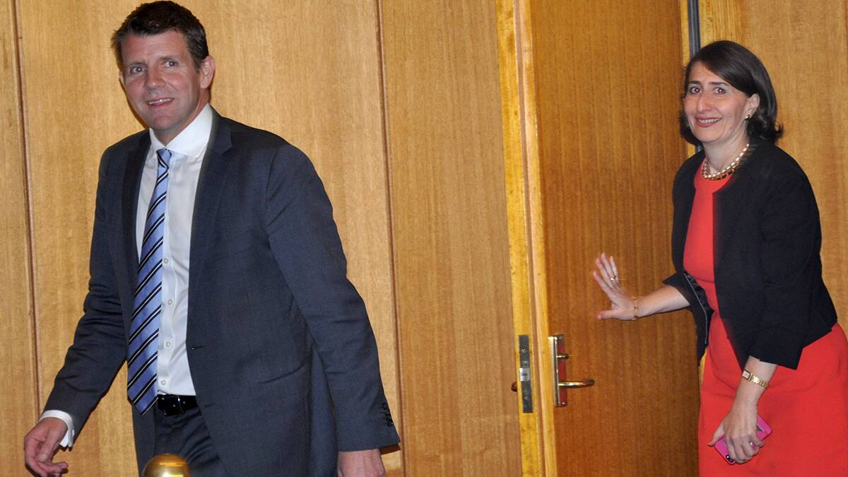 Winners: Mike Baird and Gladys Berejiklian leave the meeting room after they were elected unopposed.
