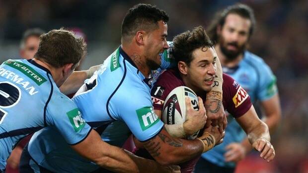 All shook up: Maroons fullback Billy Slater is tackled by Andrew Fifita. Photo: Getty Images
