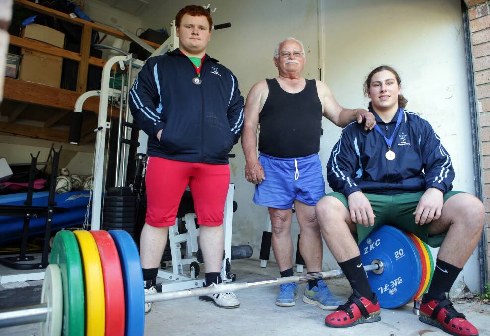 Lifting experience:  Matthew Johns (left) with coach Joe Brent and fellow weightlifter Jackson Roberts-Young. Picture Chris Lane

