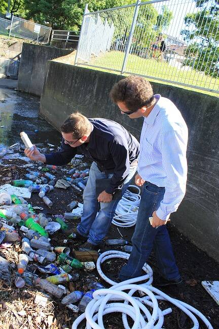 Call for action:  Mark Speakman (foreground) and Greens Senator Peter Whish-Wilson inspect litter in Cooks River.
