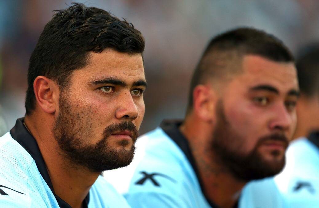 Troubled times: David and Andrew Fifita take a break on the sideline during the Cronulla Sharks and the Canberra Raiders game at Remondis Stadium on March 8. Picture: Renee McKay/Getty Images

