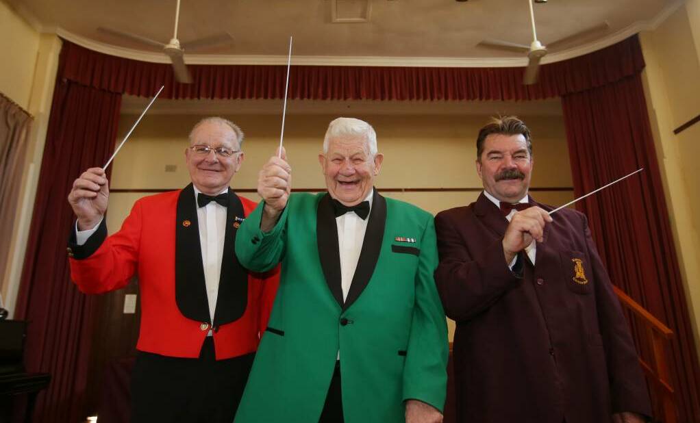 Batons at the ready: (from left) Band masters Ian Bown, Edgar Starr and Barry Davidson lead their bands in the Anzac concert tribute. Picture: Chris Lane

