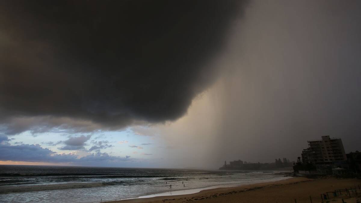 Wet start: Heavy rain in parts of Sydney as people set out for work made it less than a Fun Friday.  Leader chief photographer John Veage captured the skies over Cronulla. 