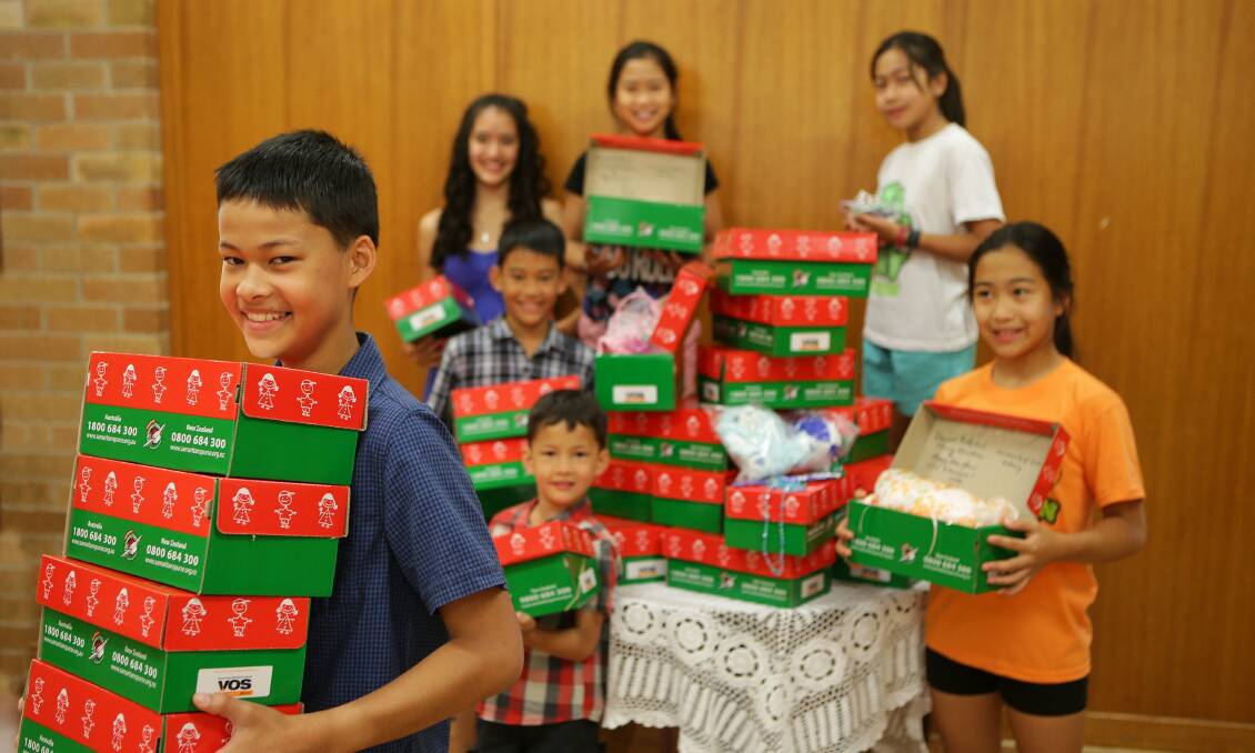 Christmas giving: Children pack boxes to send to those less fortunate. Pictured are Elisha, Zachary, Calvin, Mikaela, Kirsten, Dana and Lara. Picture John Veage.

