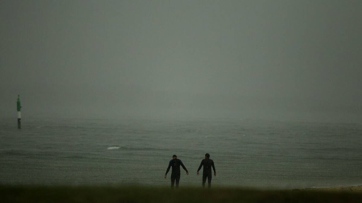 Swimmers brave the conditions at Dolls Point during today's storm. Picture Chris Lane 
