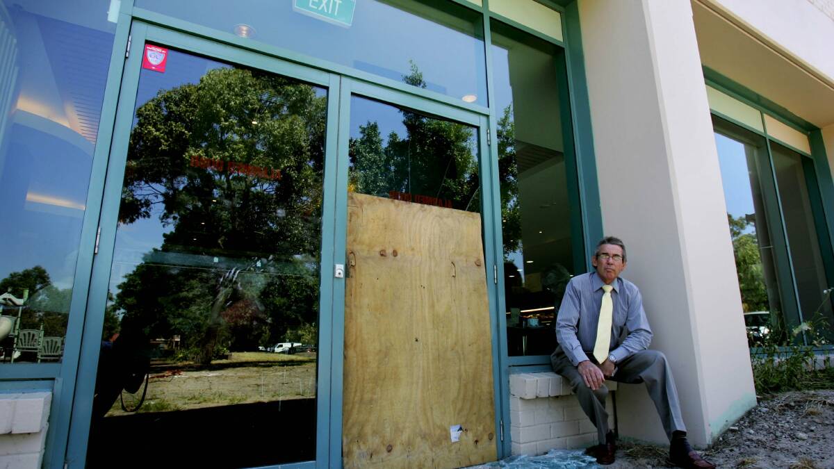 Disqualified: Former secretary Noel Neate in 2007 next to a window broken during a robbery. Picture: Chris Lane
