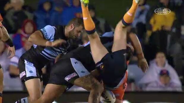 Newcastle hooker Adam Clydsdale is upended by Sharks prop Andrew Fifita. Photo: Channel 9

