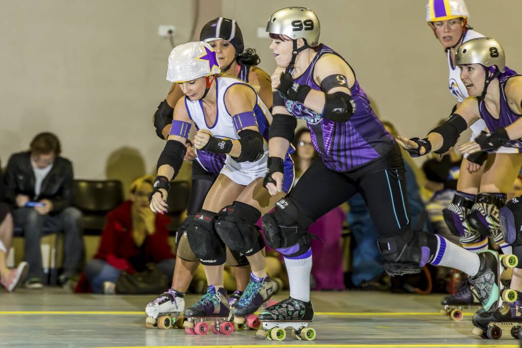 Thrills and spills:The South Side Derby Dolls in eight wheel rolling action against the Newcastle Roller Derby League in September. Picture Nick Sullivan

