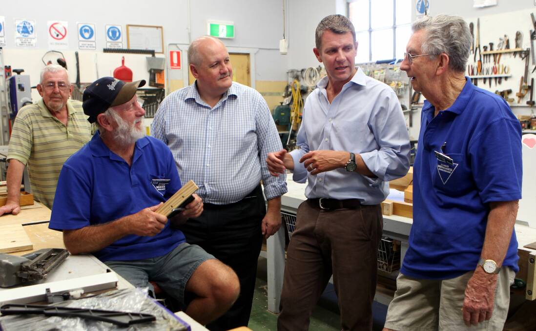 Premier to be: Mike Baird (second from right) accompanied by Heathcote MP Lee Evans chats with Jim McGuinness (left) and Frank Burgess during a visit to the Bosco Menshed at Engadine last year. Picture: Jane Dyson

