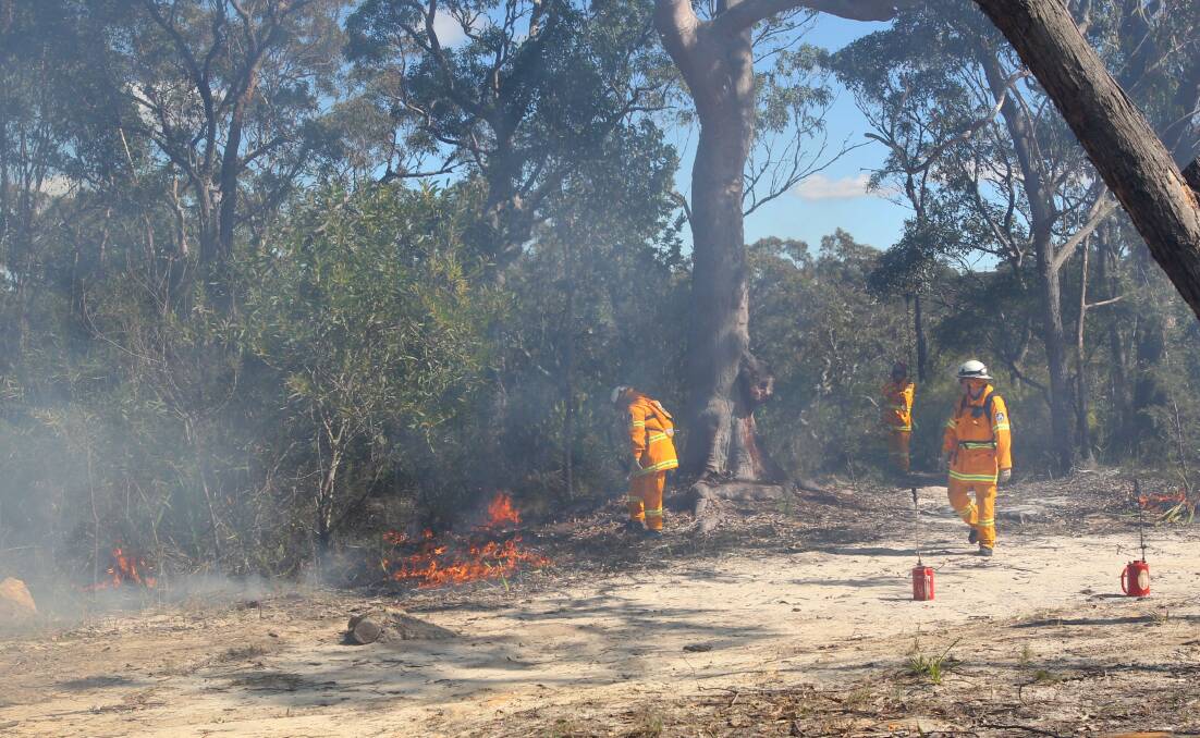 Keeping us safe: NSW Rural Fire Service volunteers doing hazard reduction burns at Engadine in August 2013. Picture: Lisa McMahon.

