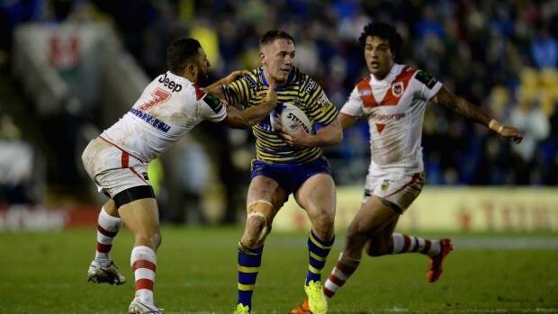 Marshall lore: Benji Marshall, left, tackles Warrington's Ben Currie. The former Tiger scored two tries in the World Club Series clash. Photo: Getty Images.
