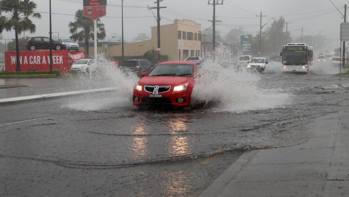 Flash flood: Motorists drive through flooded roads, including the Princes Highway at Carlton, as a severe storm hit Sydney. Picture: Jane Dyson
