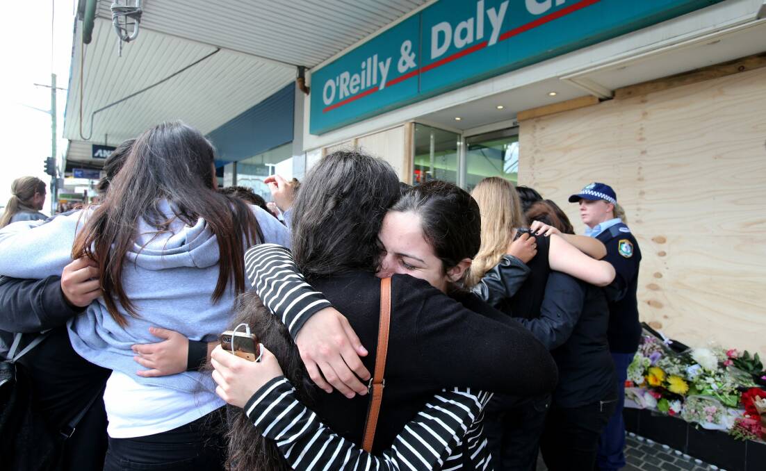 Community comfort: People support each other at a memorial outside the chemist the day after the accident where Aneri Patel died. Picture: Jane Dyson
