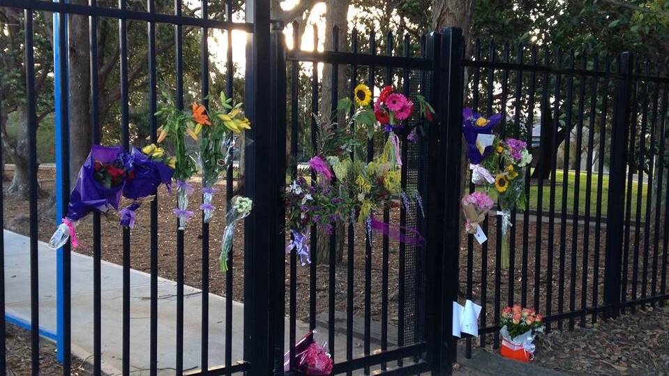A school community in mourning: Flowers on the fence  at the school where Mrs Cochrane  was a teacher. Picture: Yarrawarrah Public School on Facebook.


