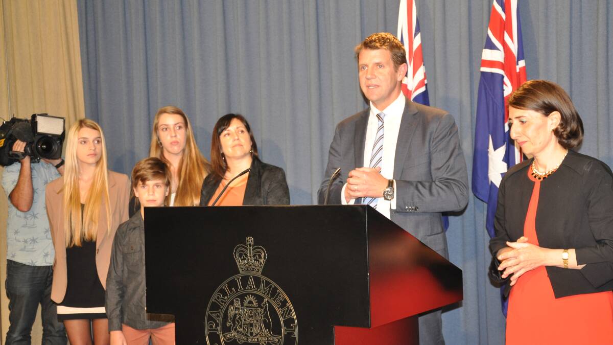 New team: Mike Baird flanked by his family and deputy leader Gladys Berejiklian.

