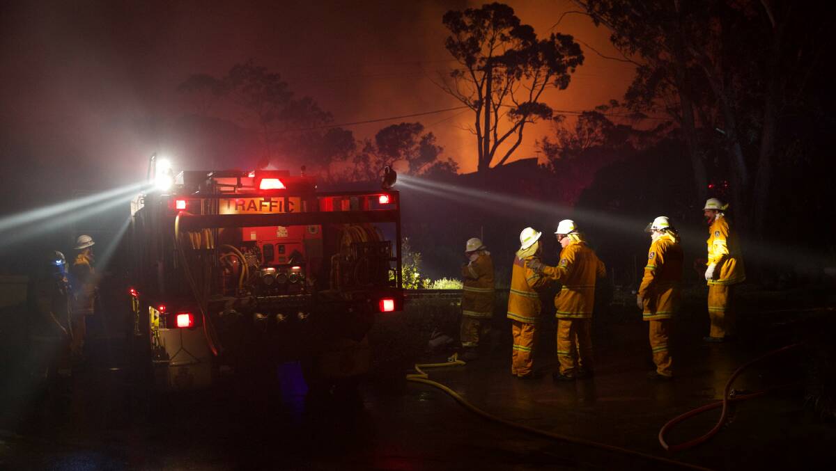 At risk: NSW Rural Fire Service crews battle an out of control fire near Wentworth Falls. Picture: Wolter Peeters.
