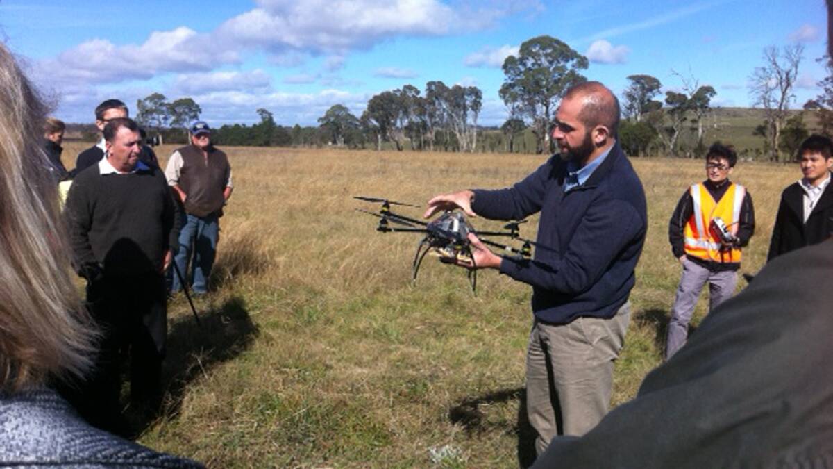 Eye in the sky: A drone being trialled at Armidale recently before NSW Noxious Weeds Committee members. Picture: Cr Kevin Schreiber

