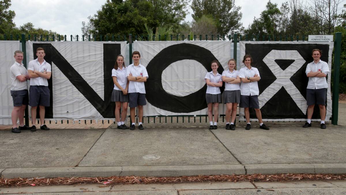 Menai High School students marked White Ribbon Day by wrapping the front of the school in a large banner that says "Menai High says no", encouraging the community to sign it. Picture: Jane Dyson


