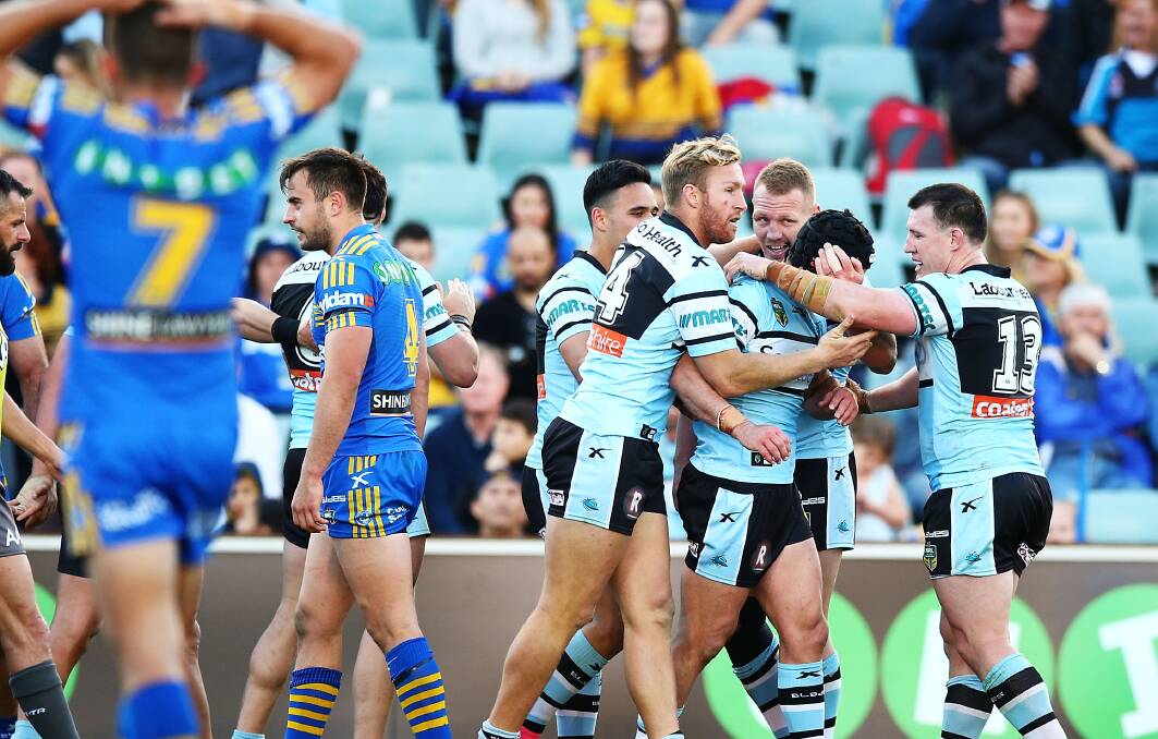 Cheers: Sharks players celebrate a try by Michael Ennis during the match between the Parramatta Eels and the Cronulla Sharks at Pirtek Stadium on August 29. Picture:  Mark Nolan/Getty Images
