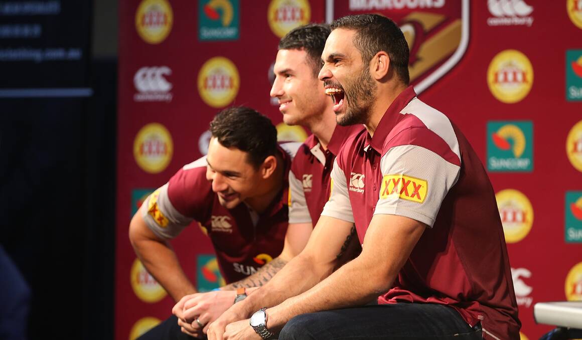 Showing their state colours: Billy Slater, Darrius Boyd and Greg Inglis share a joke during the Queensland Maroons State of Origin Team Announcement at the Brisbane Showgrounds. Picture: Chris Hyde/Getty Images.
