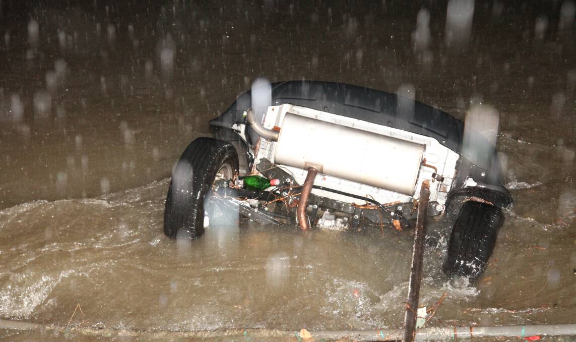 Swept away: A car was swept into a Bexley North canal on Tuesday night during the storm. Picture: Brett Cross.
