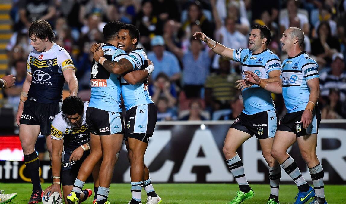 Winning streak: Ricky Leutele of the Sharks (L) celebrates after scoring a try during the round 16 NRL match between the North Queensland Cowboys and the Cronulla Sharks at Townsville. Picture: Ian Hitchcock/Getty 

