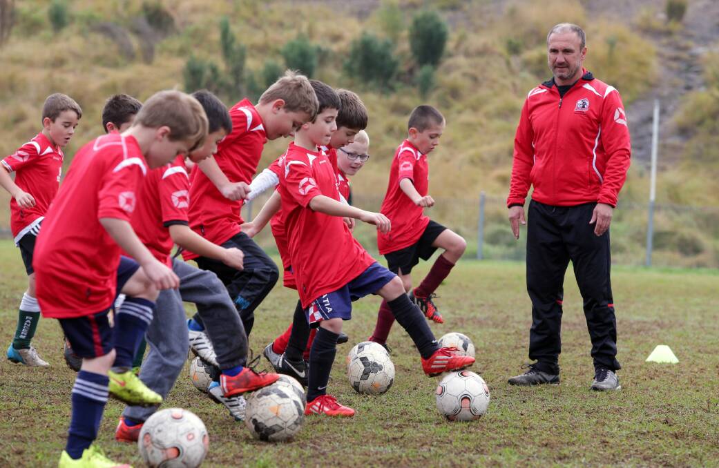 Football school: Experienced coach Aytek Genc puts youngsters through their paces at Peakhurst Park on Tuesday, June 30. Picture: Jane Dyson
