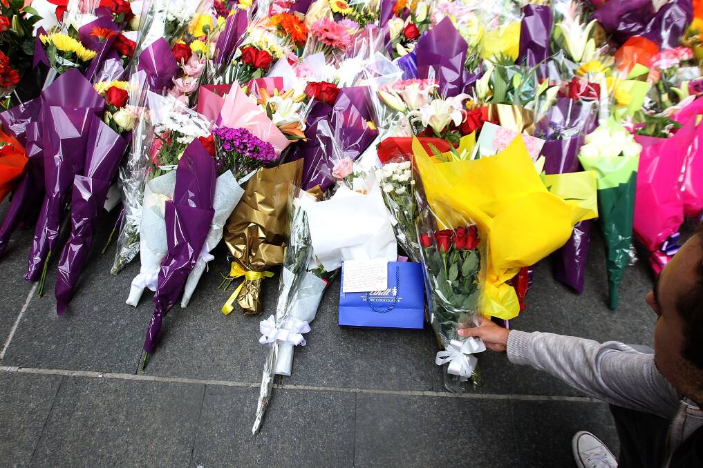 Always remembered: People lay flowers at Martin Place after the seige in Sydney on Monday. Picture: Ben Rushton/Fairfax Media
