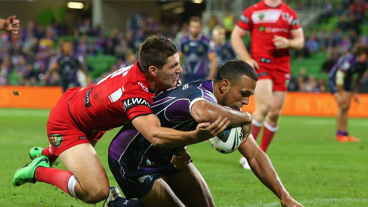 The Storm’s Will Chambers breaks through a tackle by Dragons Gareth Widdop. Picture: Quinn Rooney/Getty Images
