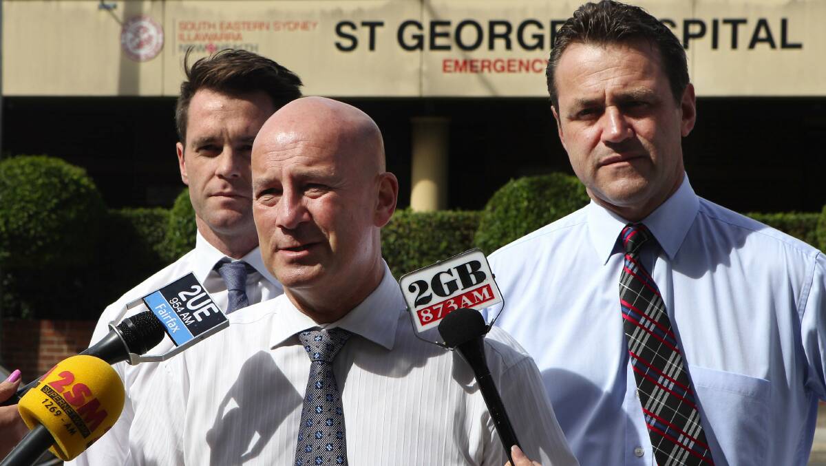 On the attack: John Robertson with Labor candidates Chris Minns and Steve Kamper outside St George Hospital.Picture: John Veage

