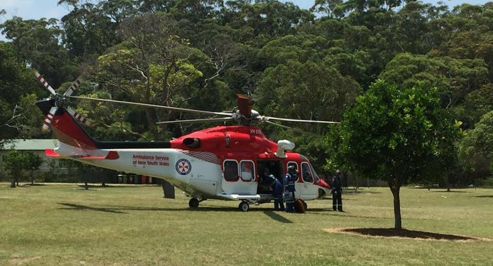 A helicopter lands in the park to assist the injured men. Pictures: Bundeena Fire Station.

