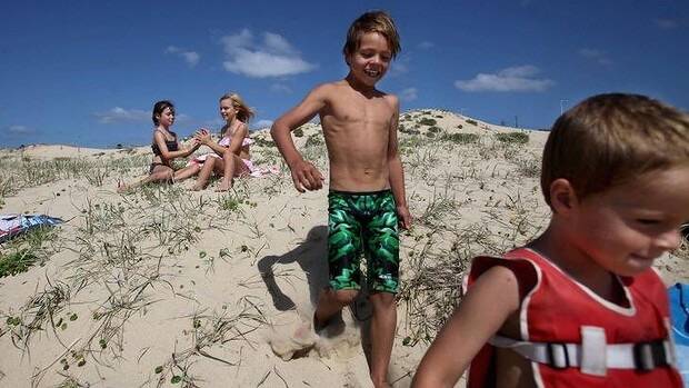 Fun in the sun: Children play in the sand dunes at Cronulla Beach on Saturday. Photo: Fiona Morris
