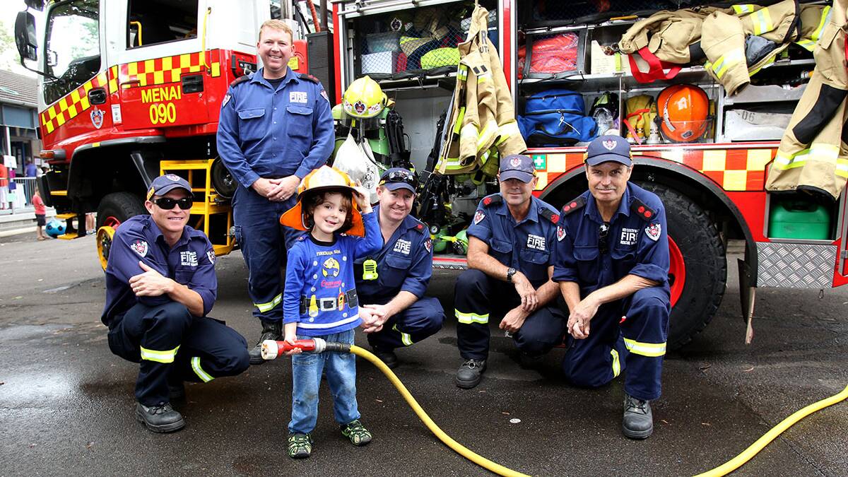  Little Noah 3 from Oatley just loves fire engines, pictured here with Mortdale and Menai firefighters. Picture : Lisa McMahon.