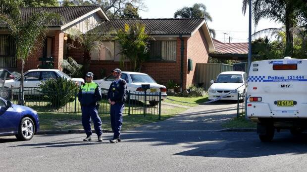 Police outside the home where Paul Streeter was found dead. Photo: Jane Dyson