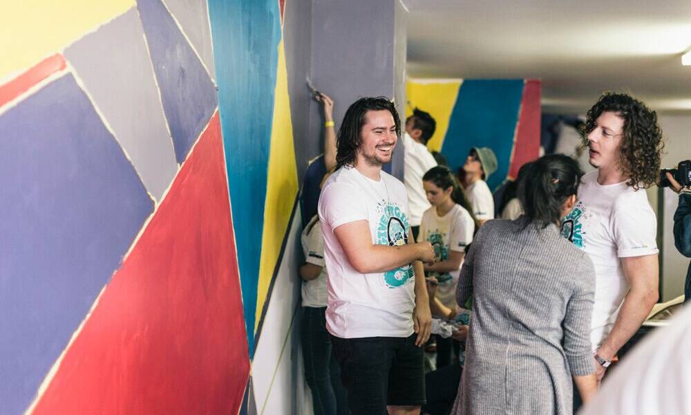Peking Duk painters: the musical duo joined Optus RockCorps volunteers for a good cause.  Pictures: Aleksandar Jason
