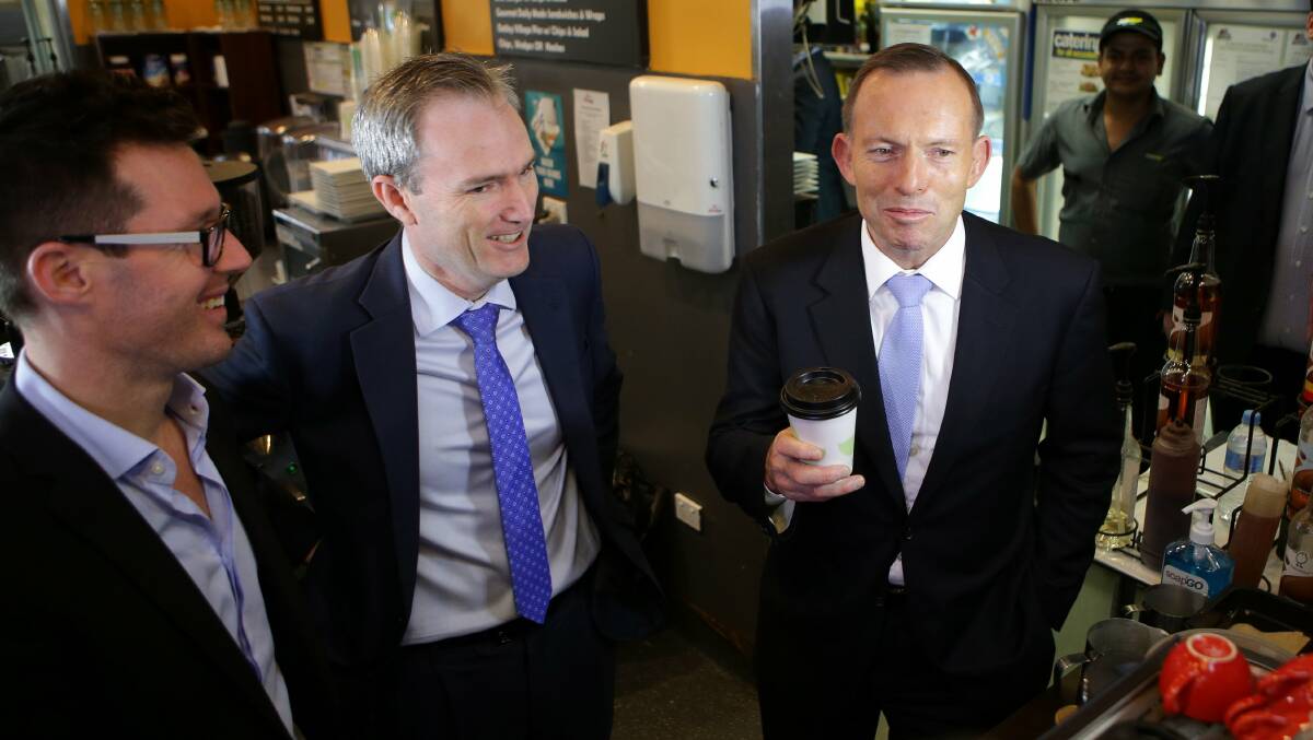 Coffee up: Mr Abbott received a glowing endorsement of the budget from Matt Alderton, who owns three adjoining businesses: Buzzbar Espresso, Network Video and Subway.