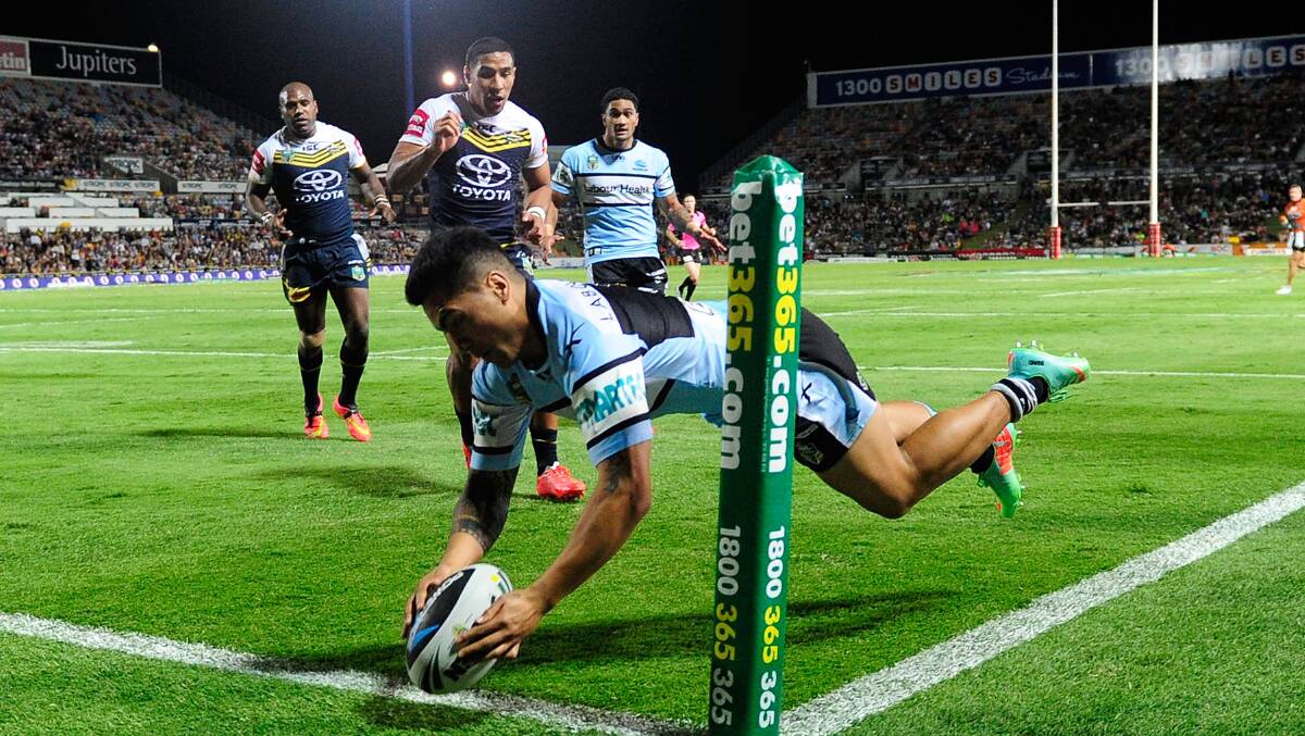 Try: Sharks winger Sosaia Feki scores against the Cowboys on Monday night. Picture: Ian Hitchcock, Getty Images