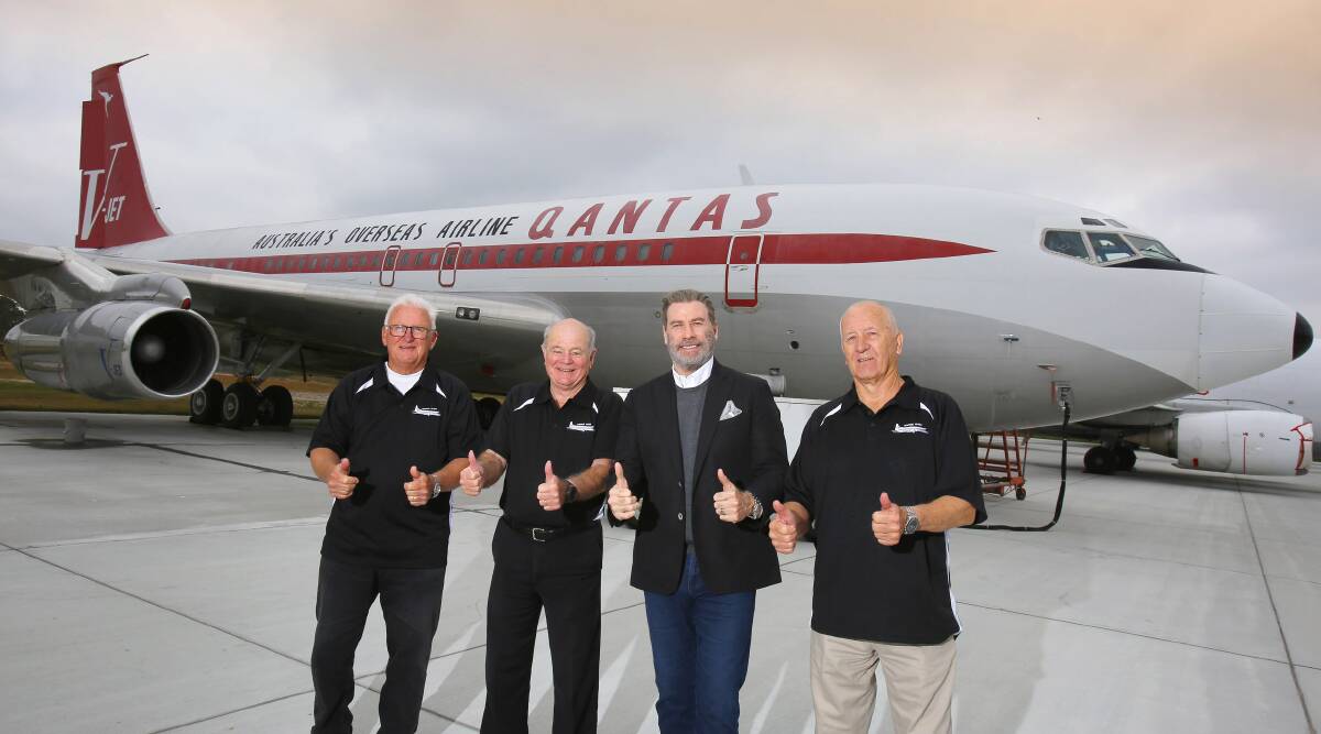 John Travolta officially hands over his Boeing 707 to HARS members Peter Elliott (left), John Dennis and Frank Bowden at Brunswick's Golden Isles Airport in Georgia USA on Sunday. Picture: Andy Zakeli / www.lenswork.com.au
